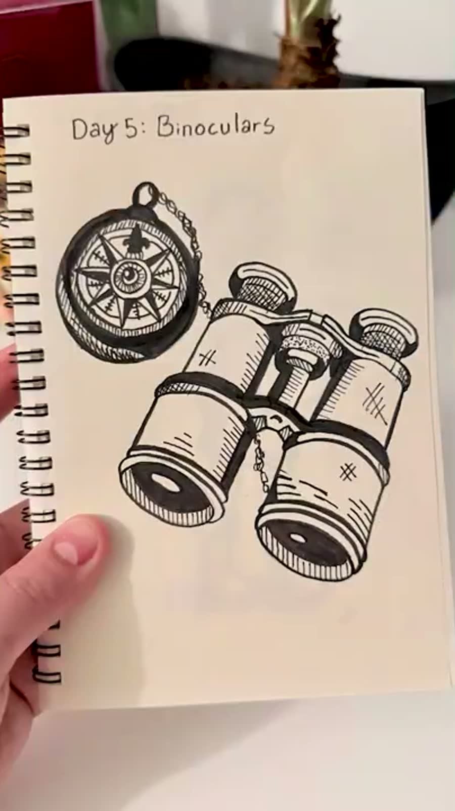 Inktober binoculars drawing with a chain detail added around the binoculars.